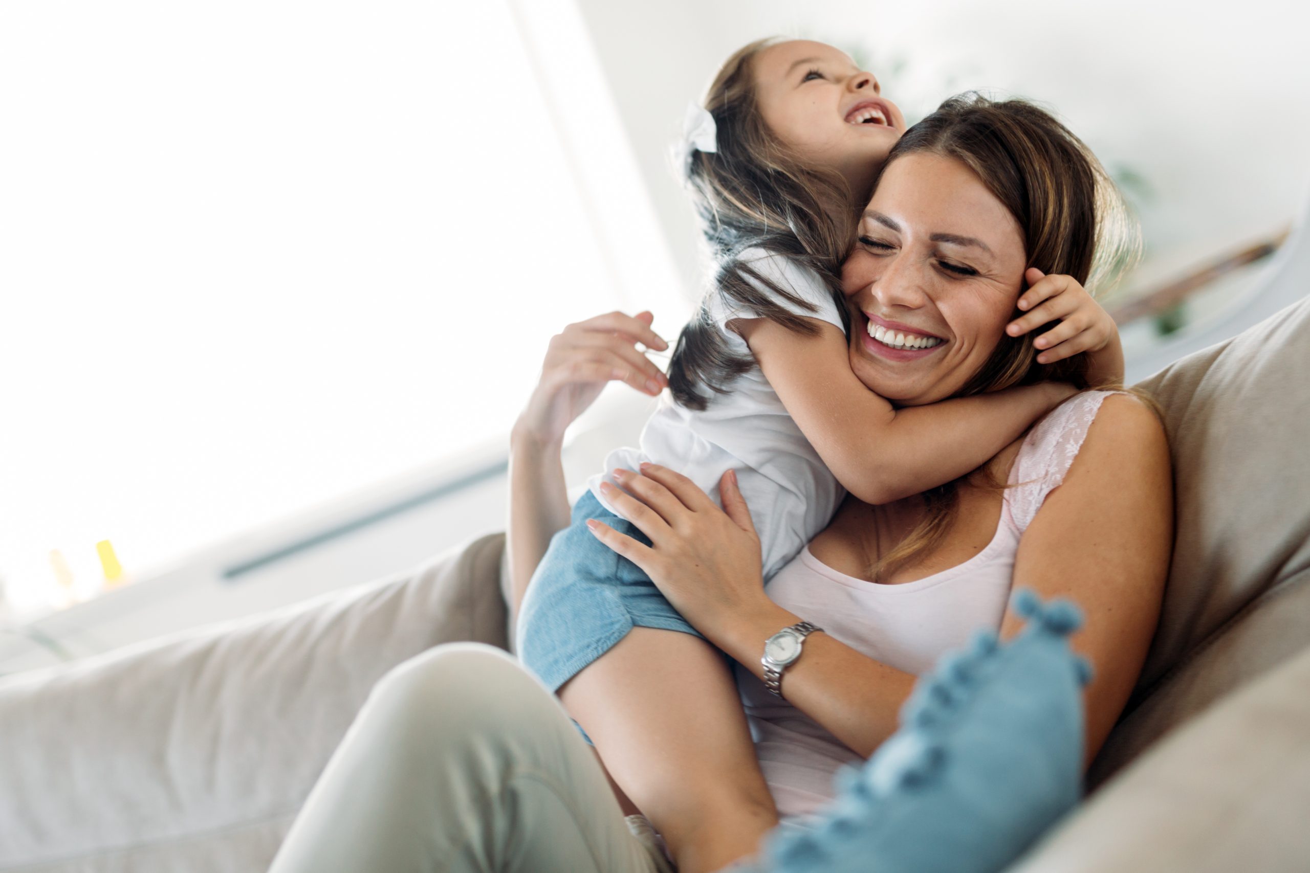 A mother holding her daughter close